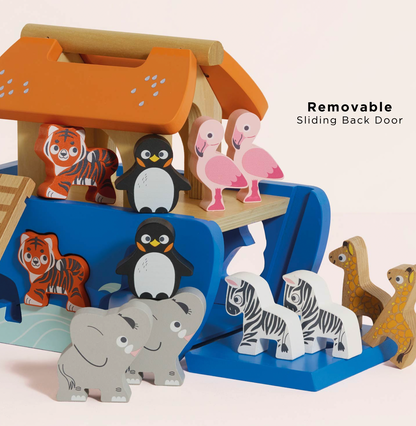 A wooden animal-themed toy set arranged on a blue and orange playhouse structure. The set includes pink flamingos, gray elephants, white-and-black zebras, brown-and-cream giraffes, black-and-white penguins, and orange-and-cream striped animals.