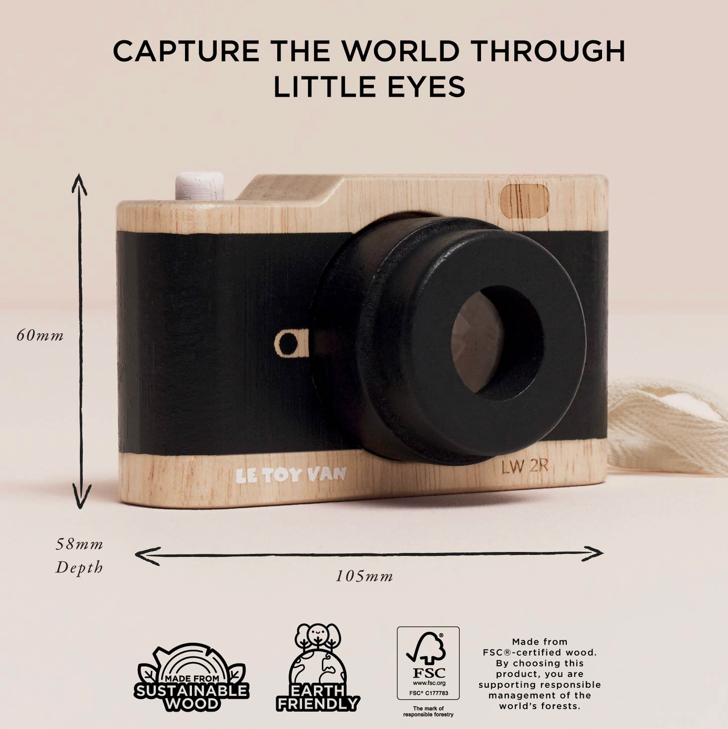 A wooden toy camera with a black body and natural wood edges, shown with dimension arrows and text indicating 60mm height, 58mm depth, and 105mm width. The top of the image reads 'CAPTURE THE WORLD THROUGH LITTLE EYES' and the bottom includes sustainability and FSC certification icons.