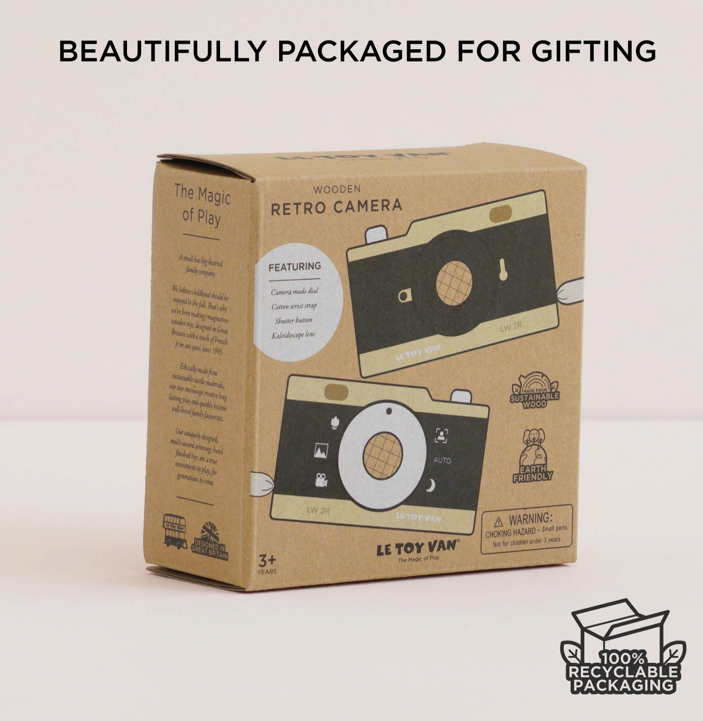 LE TOY VAN 'Retro Camera' wooden toy packaging box, featuring a brown kraft cardboard design with illustrations of a wooden camera. The box is shown on a light beige background with promotional text overlays at the top and bottom.