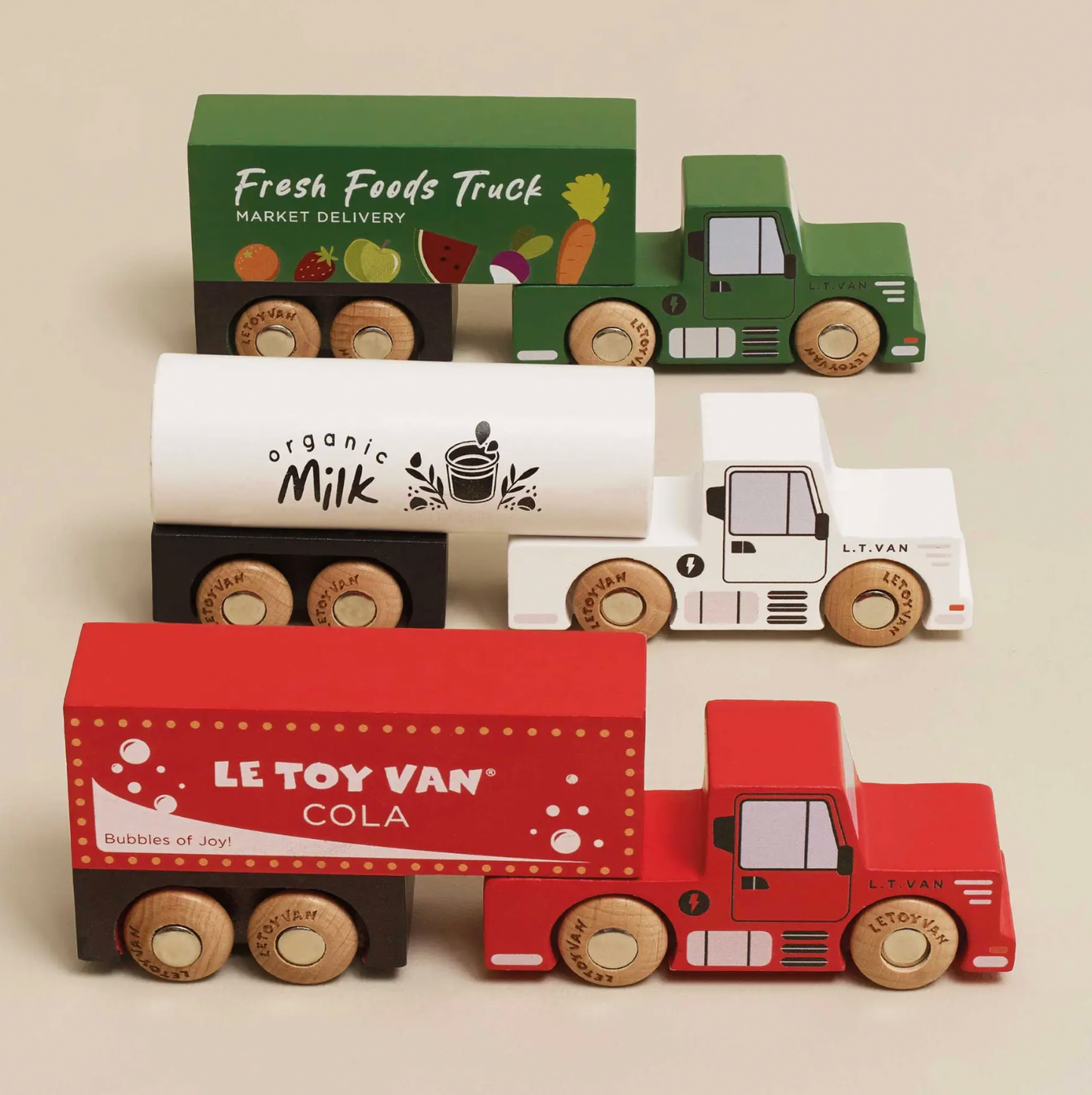 Collection of toy trucks with branding labels on a beige background