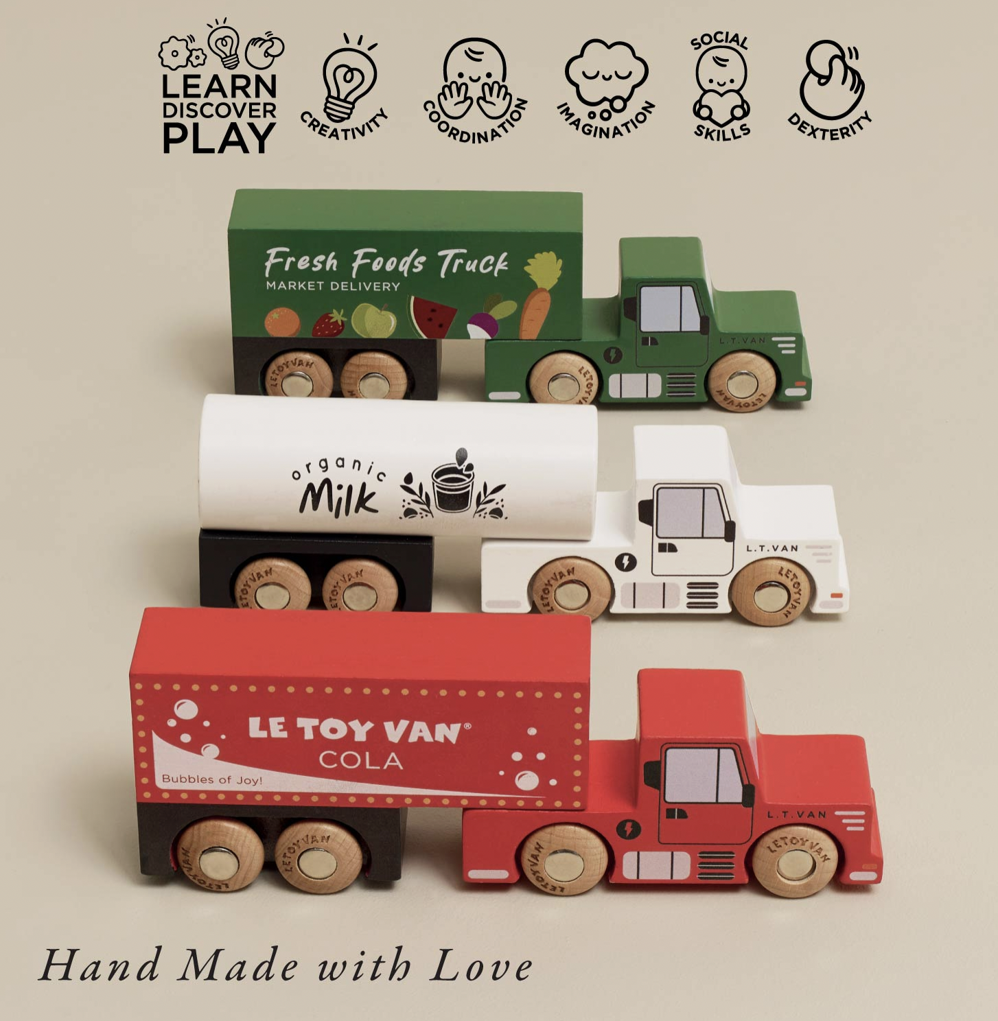 Four wooden toy trucks and trailers arranged on a beige background, with text reading 'LEARN DISCOVER PLAY' at the top and 'Hand Made with Love' at the bottom. The set includes a green market delivery truck, a white milk tanker, a red cola van, and a white tractor, all with natural wood wheels.