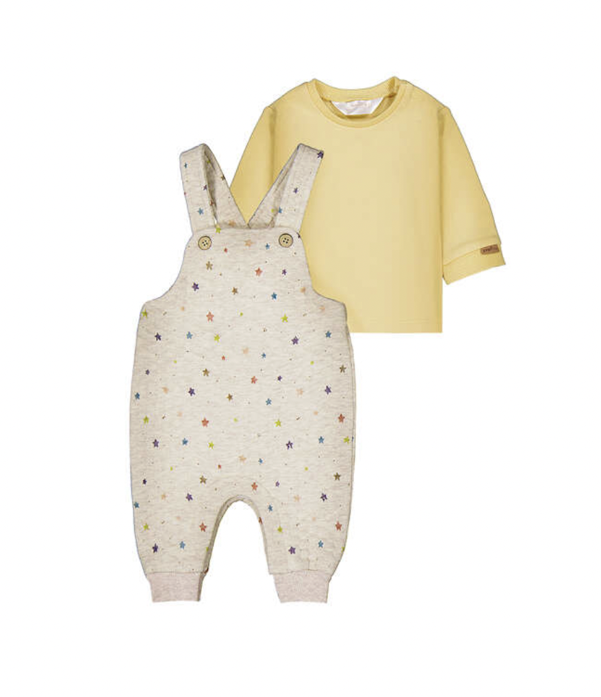 A baby clothing set featuring a cream-colored overall romper with a colorful star pattern and a solid pale yellow long-sleeve t-shirt, displayed against a plain white background.