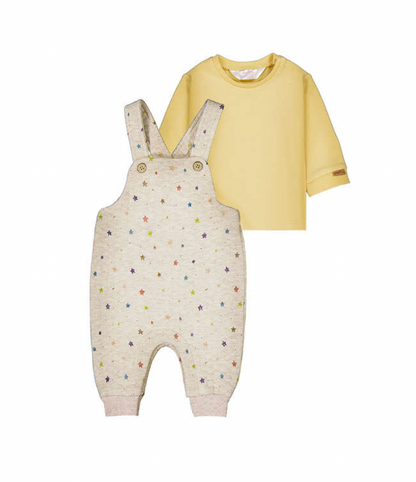 A baby clothing set featuring a cream-colored overall romper with a colorful star pattern and a solid pale yellow long-sleeve t-shirt, displayed against a plain white background.
