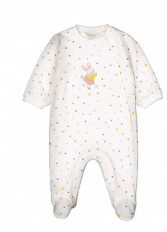 A white footed baby jumpsuit with a multicolor polka dot pattern and a small bunny graphic on the chest, shown against a plain white background.