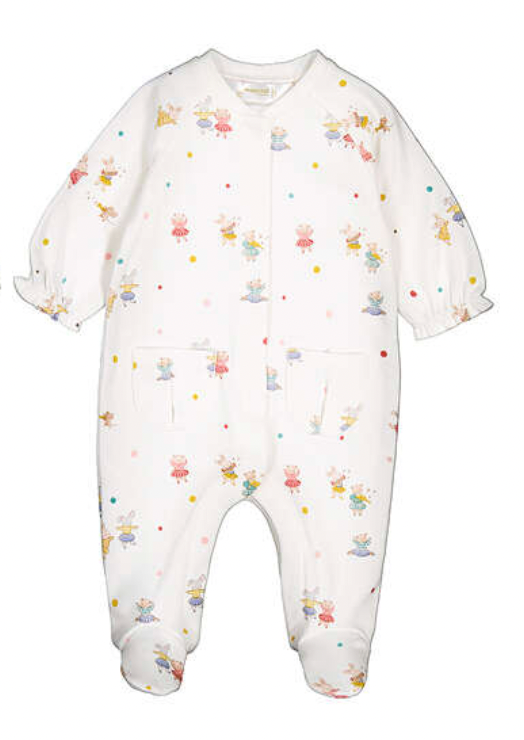 A baby footed one-piece jumpsuit in white, featuring an all-over print of small cartoon characters in various colorful outfits and scattered pastel polka dots.