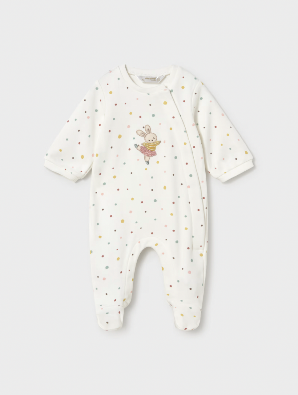 A baby long-sleeve footless sleeper in off-white, decorated with small multicolored polka dots and a cute bunny graphic on the chest, shown against a light gray background.