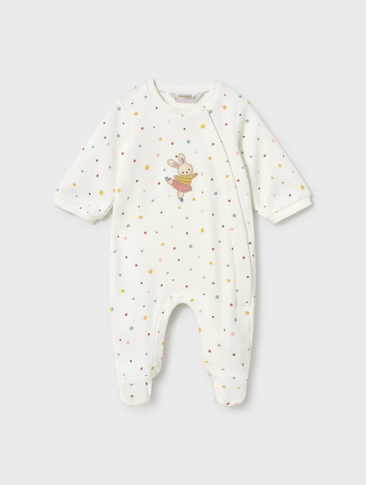 A baby long-sleeve footless sleeper in off-white, decorated with small multicolored polka dots and a cute bunny graphic on the chest, shown against a light gray background.
