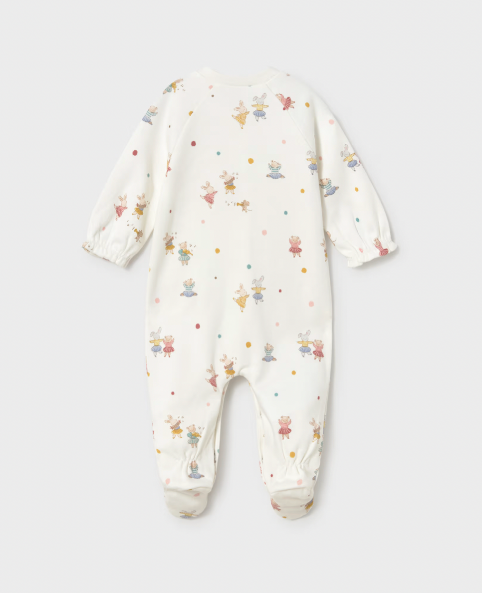 A baby long-sleeve footed sleeper in cream with a colorful cartoon bunny pattern, shown flat on a light gray background.