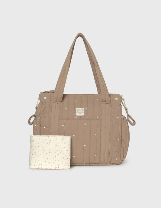 A beige quilted diaper bag with silver rhinestone accents and a matching cream-colored pouch with tiny gold speckles, displayed on a light gray background.