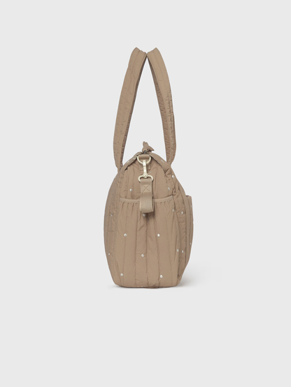 A taupe quilted nylon shoulder bag with silver studs and a gold-tone metal clasp, shown from the back on a light gray background.
