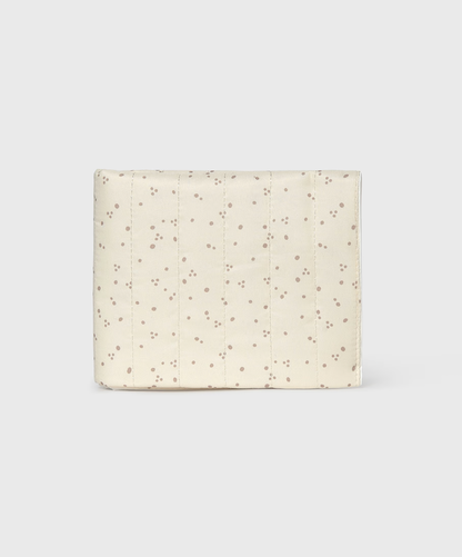 A cream-colored quilted fabric pouch with a delicate brown dotted pattern, shown against a light gray background.