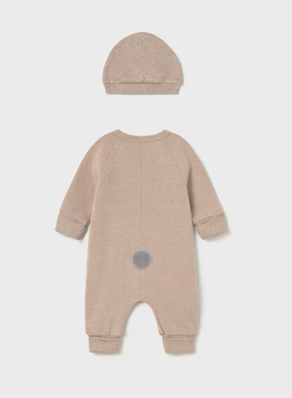 A baby one-piece romper and matching bonnet set in a heathered light taupe-beige color, shown from the back on a light gray background.
