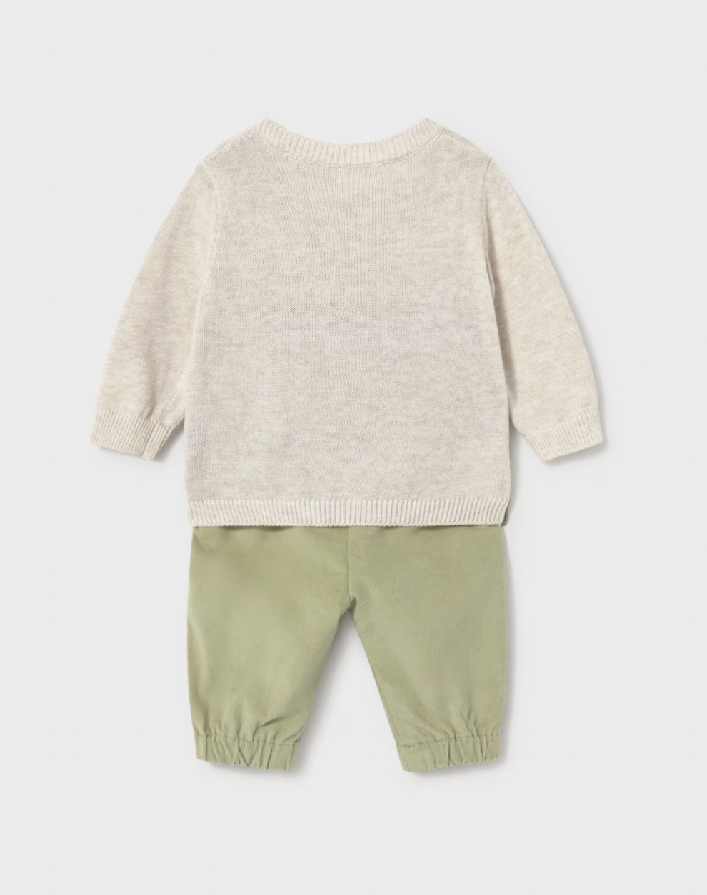 A baby two-piece knit outfit shown from the back, featuring a light cream heathered long-sleeve sweater and sage green corduroy pants with elastic cuffs, on a light gray background.