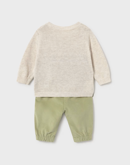 A baby two-piece knit outfit shown from the back, featuring a light cream heathered long-sleeve sweater and sage green corduroy pants with elastic cuffs, on a light gray background.
