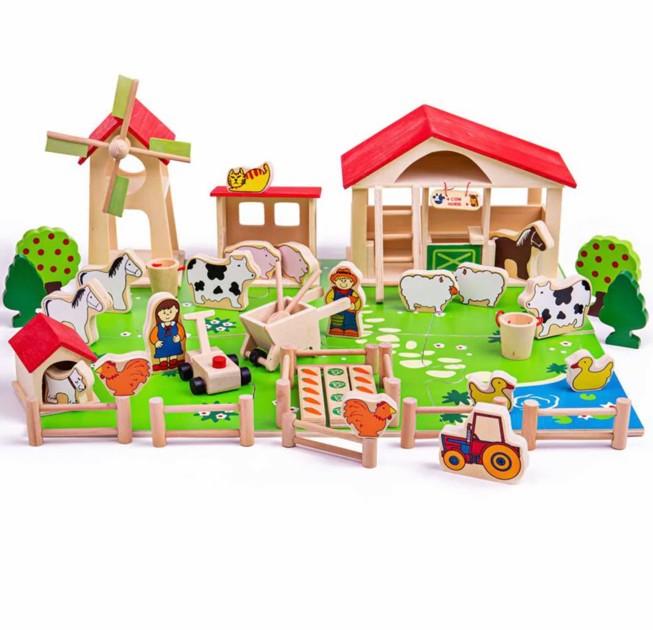 A wooden farm playset with multiple colorful pieces including a barn, windmill, tractor, cows, sheep, chickens, horses, trees, and small character figures, arranged on a white background.