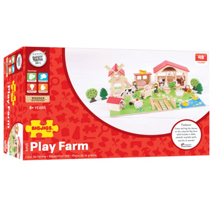 Big Jigs Play Farm wooden toy set in its red retail packaging, featuring a complete farm scene with a windmill, barn, cow, sheep, and small animals on a green field.