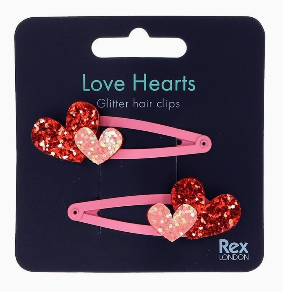 Two pink glitter hair clips with red and pink heart charms, displayed on a black card labeled 'Love Hearts Glitter hair clips' with the Rex London brand logo.