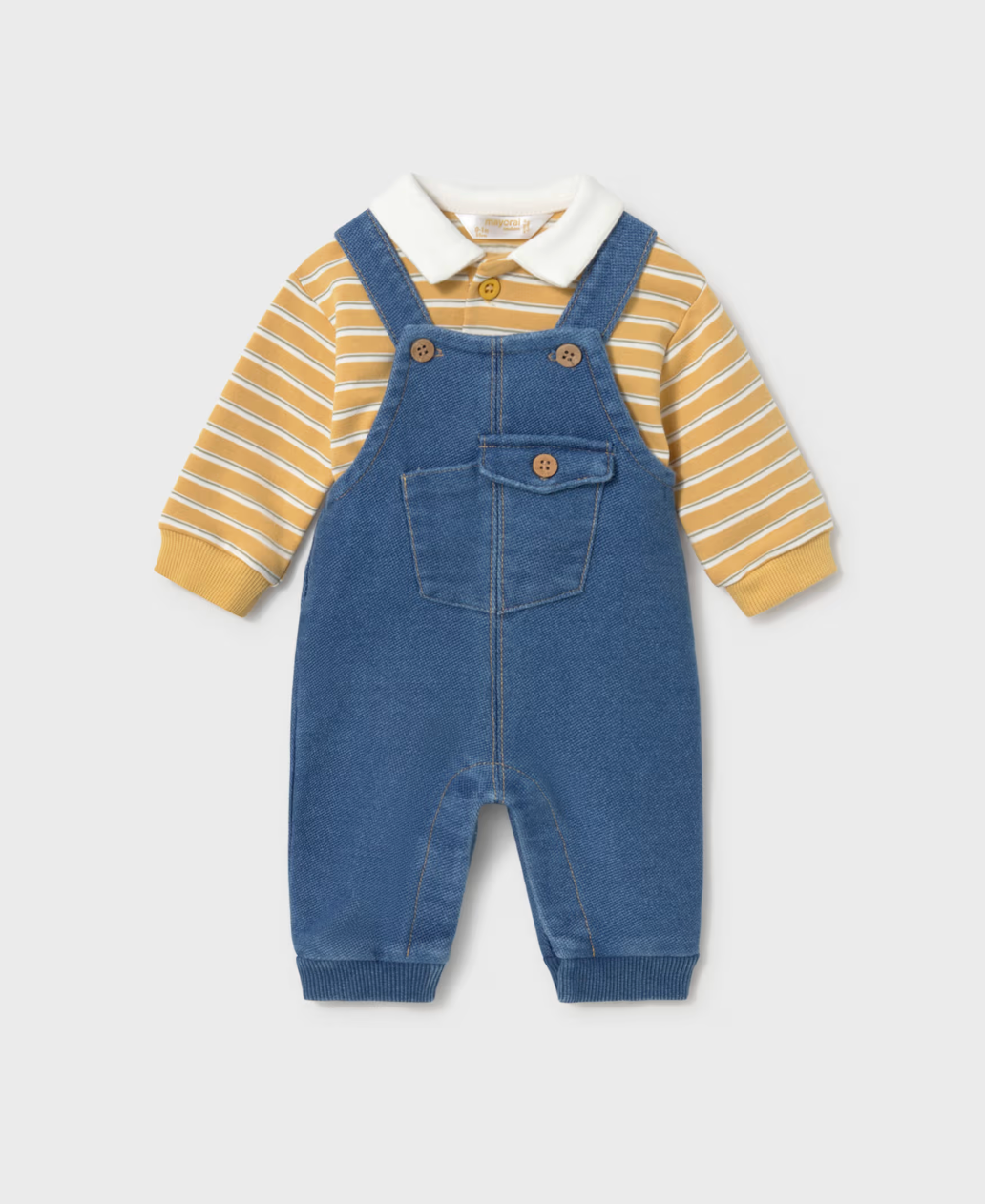 A baby boy's two-piece outfit featuring blue denim overall over a yellow and white striped long-sleeve polo shirt, displayed on a light gray background.
