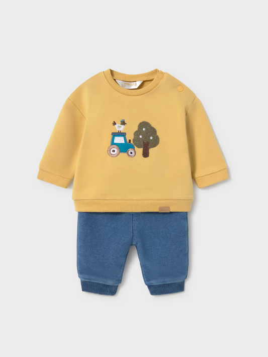 A children's two-piece outfit set featuring a yellow sweatshirt with a blue tractor and tree graphic on the chest, paired with blue pants, shown against a light gray background.
