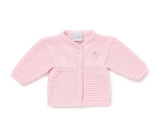 Dandelion pink matinee baby cardigan — product flat lay showing soft baby pink cardigan with smooth fine knit upper body, small knitted bow accent on chest, two self-coloured button-front closure, horizontal ladder stitch lower body panel with delicate picot frill at the join, ribbed long sleeves and ribbed hem, Dandelion label visible, on white background