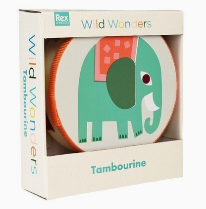 Rex London Wild Wonders elephant tambourine — front view in packaging box labelled "Wild Wonders Tambourine" showing the teal elephant with orange-and-pink patterned blanket printed on the natural wood drum face, orange fabric-wrapped rim and multicolour jingle cymbals visible at the sides