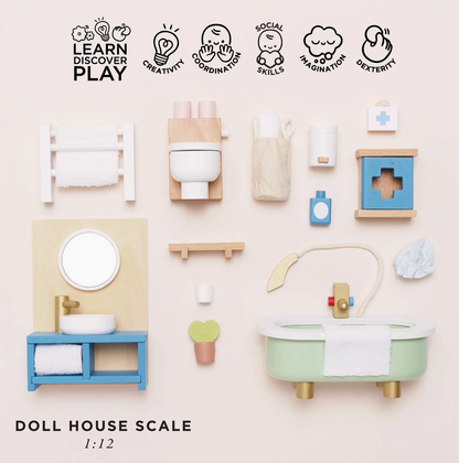 Le Toy Van wooden bathroom dolls house furniture set — flat lay of all pieces with "Doll House Scale 1:12" label and play skills icons for creativity, coordination, social skills, imagination and dexterity; includes roll-top bath, vanity unit, toilet, towel rail, first aid cabinet, shampoo bottle, toothbrush cup, bath mat and bath puff