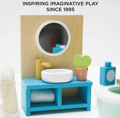 Le Toy Van wooden bathroom dolls house furniture set — close-up detail of the teal open vanity unit with round mirror panel, white vessel sink, gold tap, rolled blue towel on shelf and miniature heart-leaf cactus in a terracotta pot; "Inspiring Imaginative Play Since 1995" text