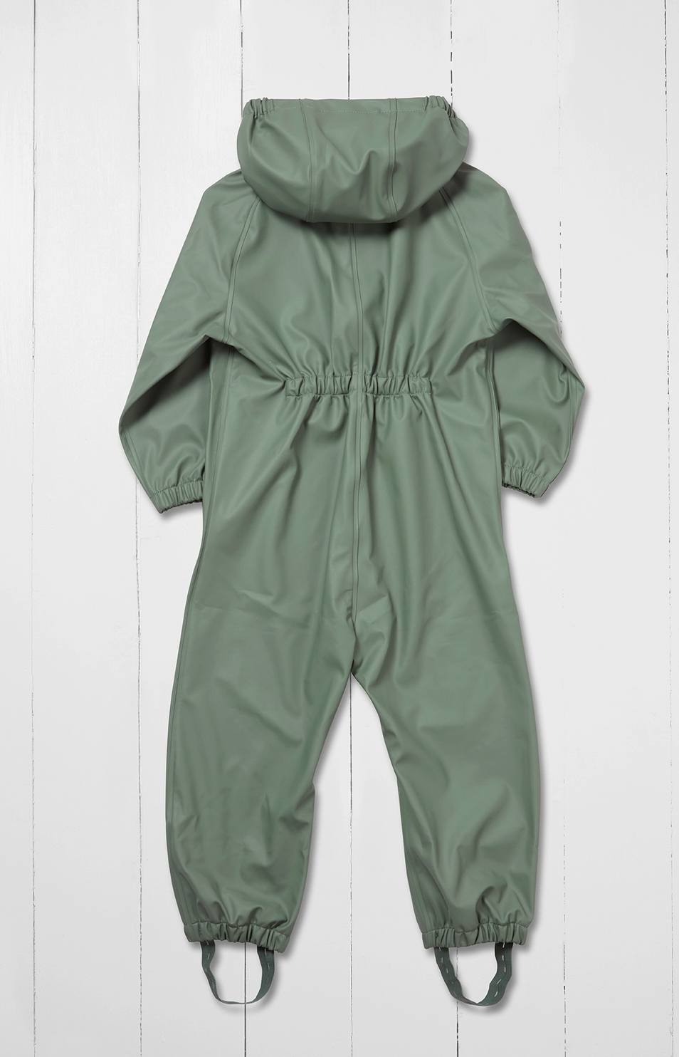 Grass & Air children's waterproof puddle suit in muted sage khaki green — back view flat lay on white background showing attached hood, elasticated back panel at waist for shape and fit, long sleeves and full-length legs with integrated boot stirrups
