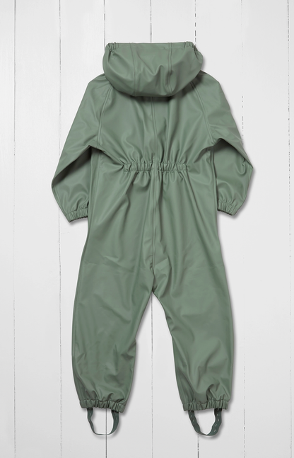 Grass & Air children's waterproof puddle suit in muted sage khaki green — back view flat lay on white background showing attached hood, elasticated back panel at waist for shape and fit, long sleeves and full-length legs with integrated boot stirrups