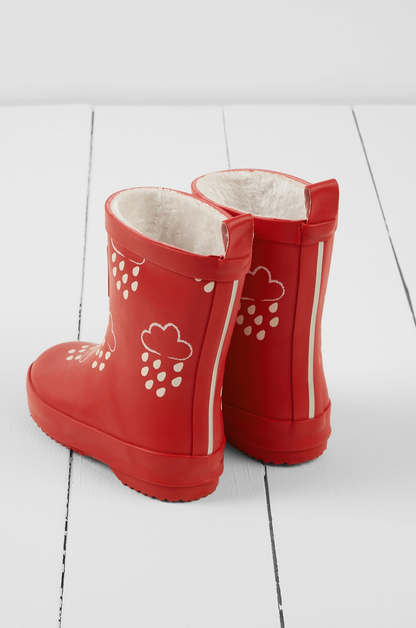 Grass & Air children's ruby red colour-changing wellies — back view showing two pull-on loops, reflective strip running up the back seam for low-light visibility, and cream cloud-and-raindrop motifs on the ruby red rubber