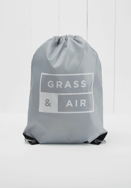 Grass & Air branded grey drawstring storage bag included with the Ruby Colour-Changing Wellies — grey nylon bag with white Grass & Air logo print