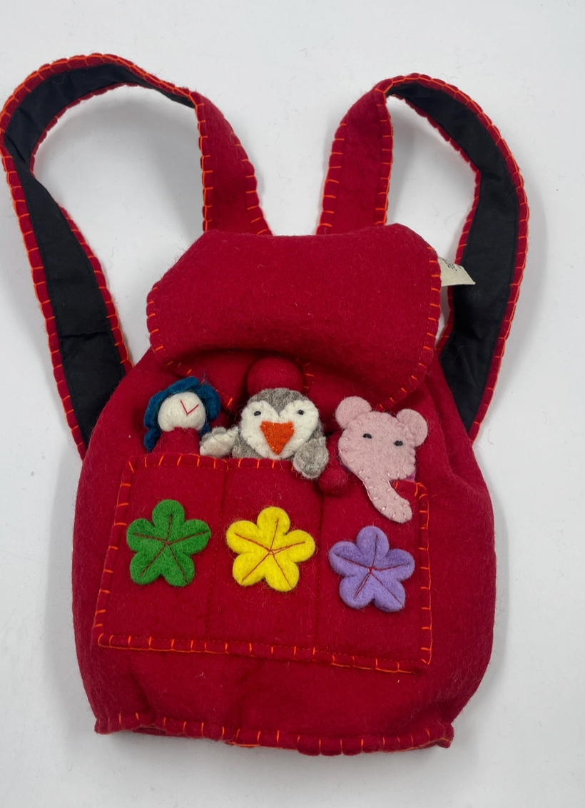 Funky Yak handmade red wool felt finger puppet backpack — front view showing open flap with three finger puppets (blue bird, penguin and pink elephant) peeking out of the front pocket, three appliquéd felt flowers in green, yellow and lavender, and padded navy-lined backpack straps