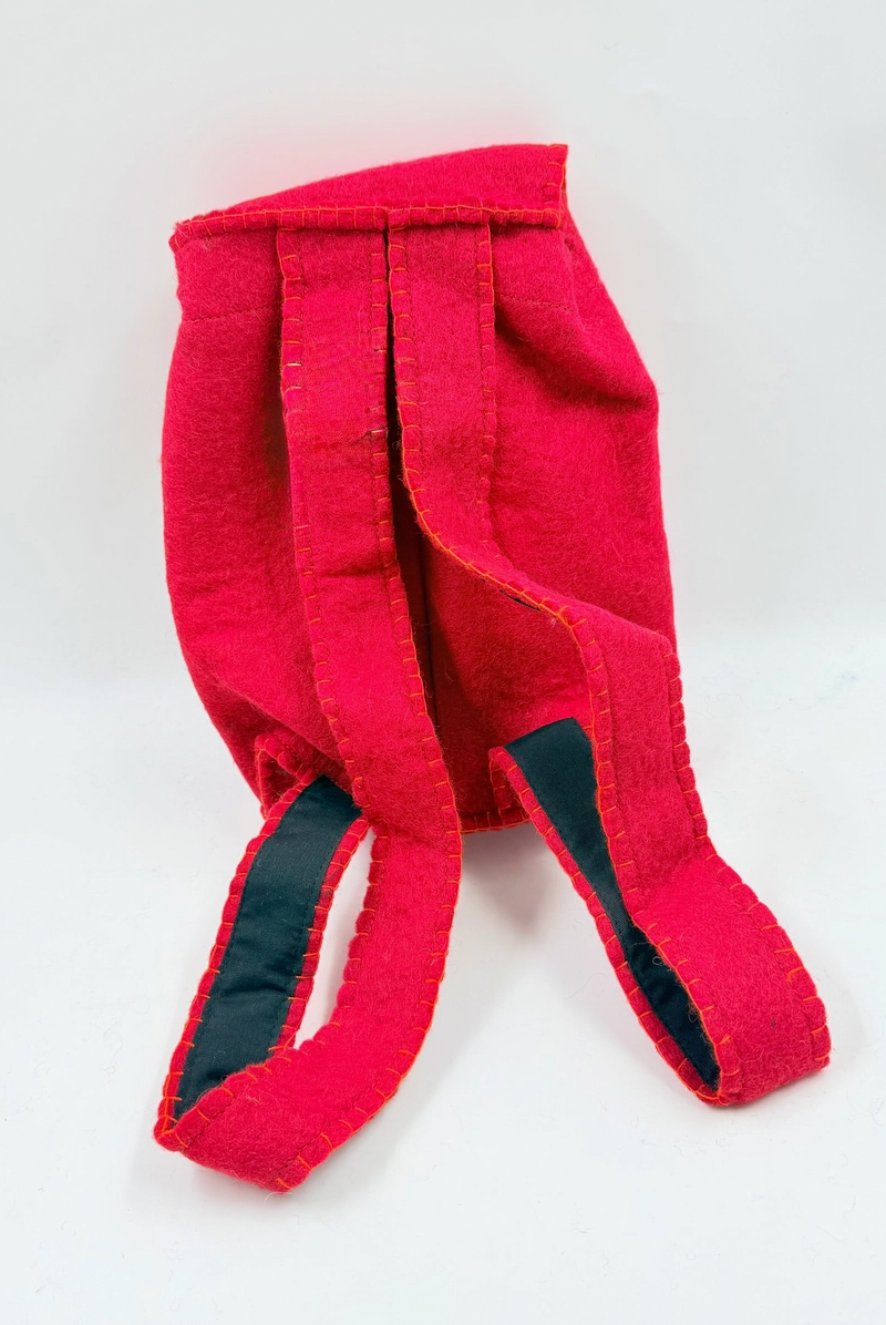 Funky Yak handmade red wool felt finger puppet backpack — back view showing the two padded backpack straps lined in navy fabric with orange blanket-stitch detailing throughout
