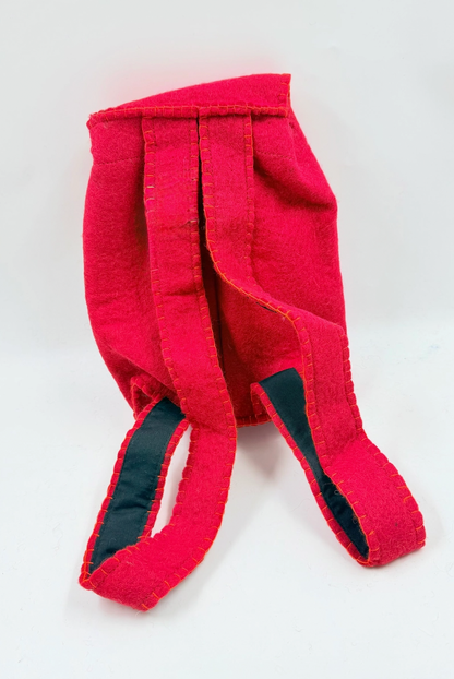Funky Yak handmade red wool felt finger puppet backpack — back view showing the two padded backpack straps lined in navy fabric with orange blanket-stitch detailing throughout