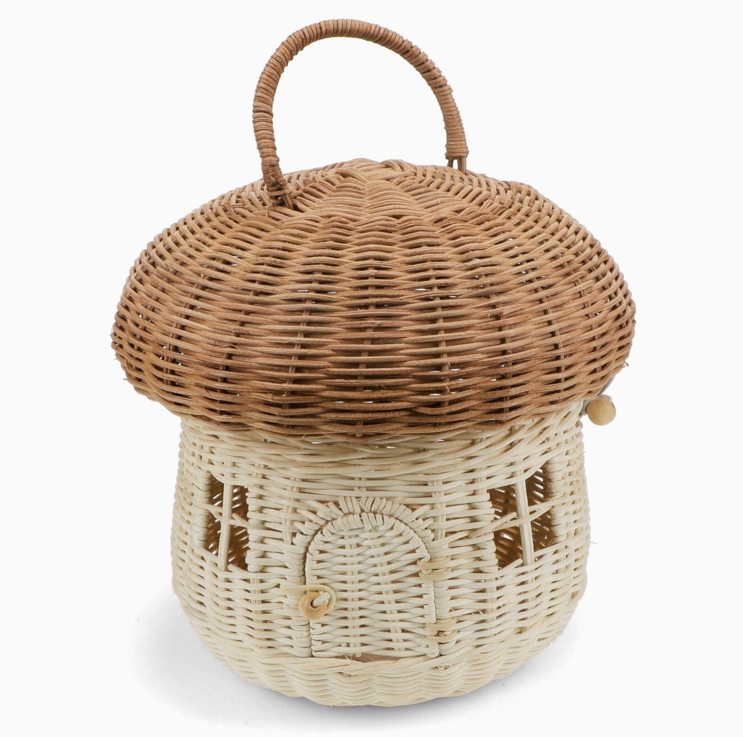 Rex London Wonders of Nature rattan mushroom house decorative basket — front view showing the two-tone design with warm honey-brown domed woven cap with looped rattan carry handle, and pale cream woven body with woven lattice window details and arched doorway with wooden bead button closure; elastic loop and wooden bead cap fastening visible on the side; 22cm diameter