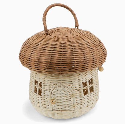 Rex London Wonders of Nature rattan mushroom house decorative basket — front view showing the two-tone design with warm honey-brown domed woven cap with looped rattan carry handle, and pale cream woven body with woven lattice window details and arched doorway with wooden bead button closure; elastic loop and wooden bead cap fastening visible on the side; 22cm diameter