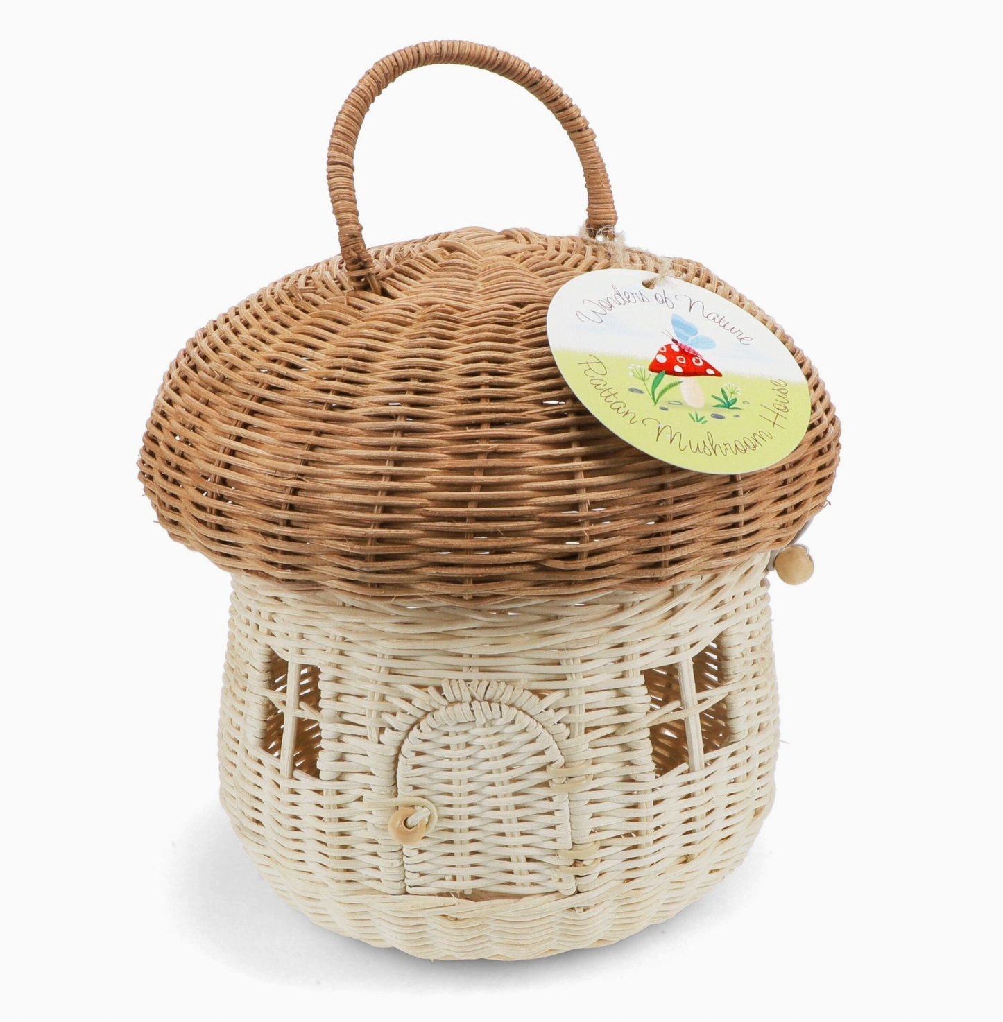 Rex London Wonders of Nature rattan mushroom house decorative basket — front view with circular card swing tag reading "Wonders of Nature Rattan Mushroom House" with illustrated red toadstool; showing honey-brown domed cap, pale cream body with arched doorway and wooden bead closure
