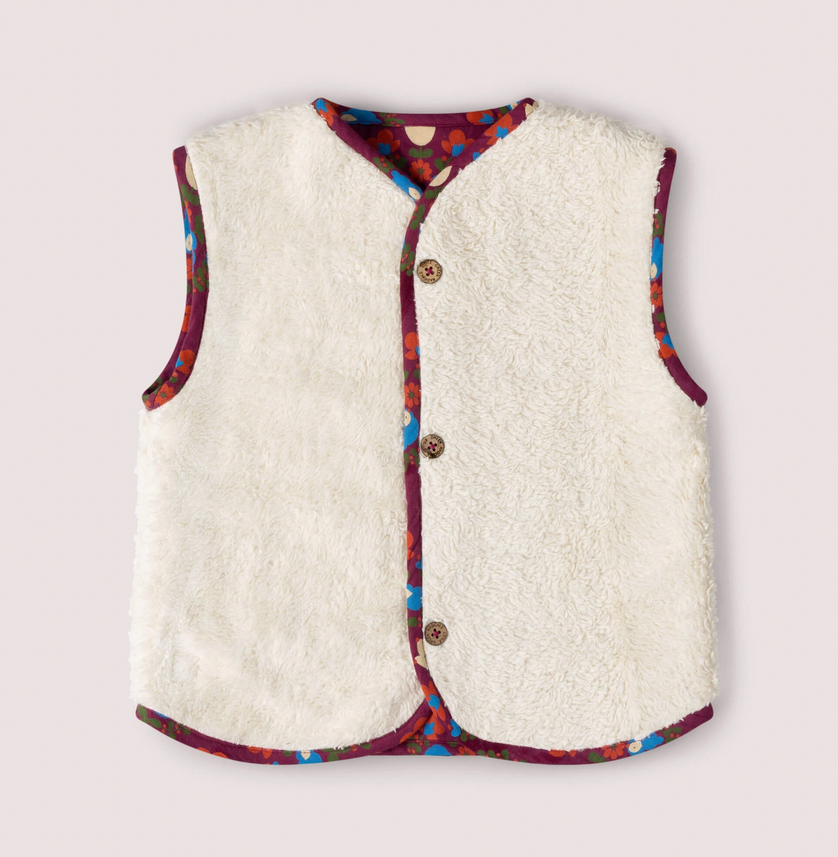 Little Green Rascals Folk Birds reversible gilet — sherpa side front flat lay showing thick fluffy natural cream organic unbleached cotton sherpa with folk birds print fabric as contrast binding trim around the neckline, armholes and hem; three branded coconut shell buttons at the front