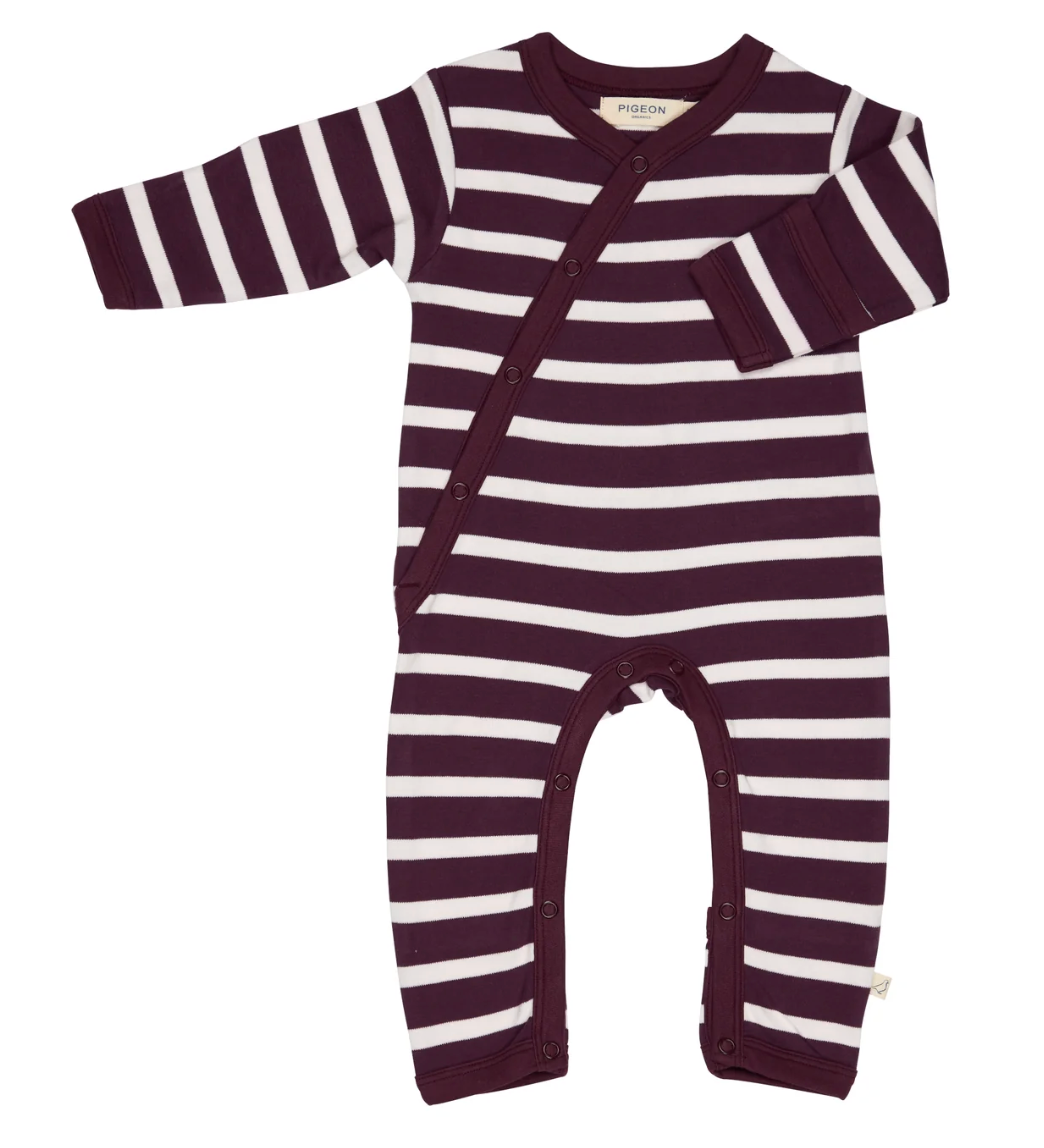 Front flat — bold plum/blush Breton stripe; kimono diagonal wrap; silver poppers; fold-over cuff shown; leg poppers; plum trims; Pigeon Organics label. 