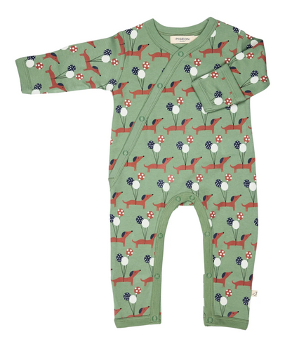 Front flat — sage green ground; terracotta dachshunds with navy ears; three-balloon bunches; kimono diagonal wrap; fold-over cuff shown; leg poppers; sage ribbed trims; Pigeon Organics label.
