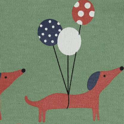 Close-up — balloon trio detail (navy polka dot, plain white, red polka dot); two dogs in trotting poses; jersey fabric texture visible. 