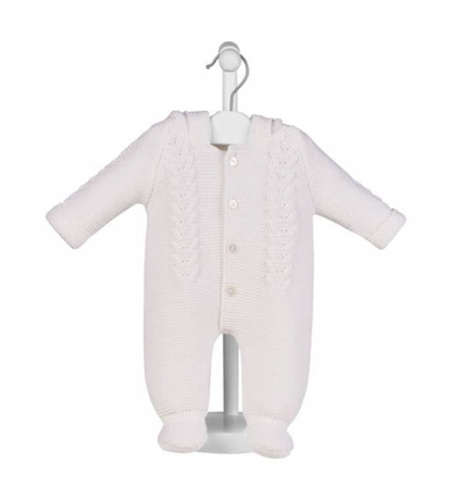 White pram suit on display stand — hood with bobble trim and ear details; cable knit front panel; 4 pearl buttons; integrated bootees; fold-over cuffs.