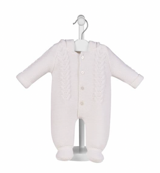 White pram suit on display stand — hood with bobble trim and ear details; cable knit front panel; 4 pearl buttons; integrated bootees; fold-over cuffs.