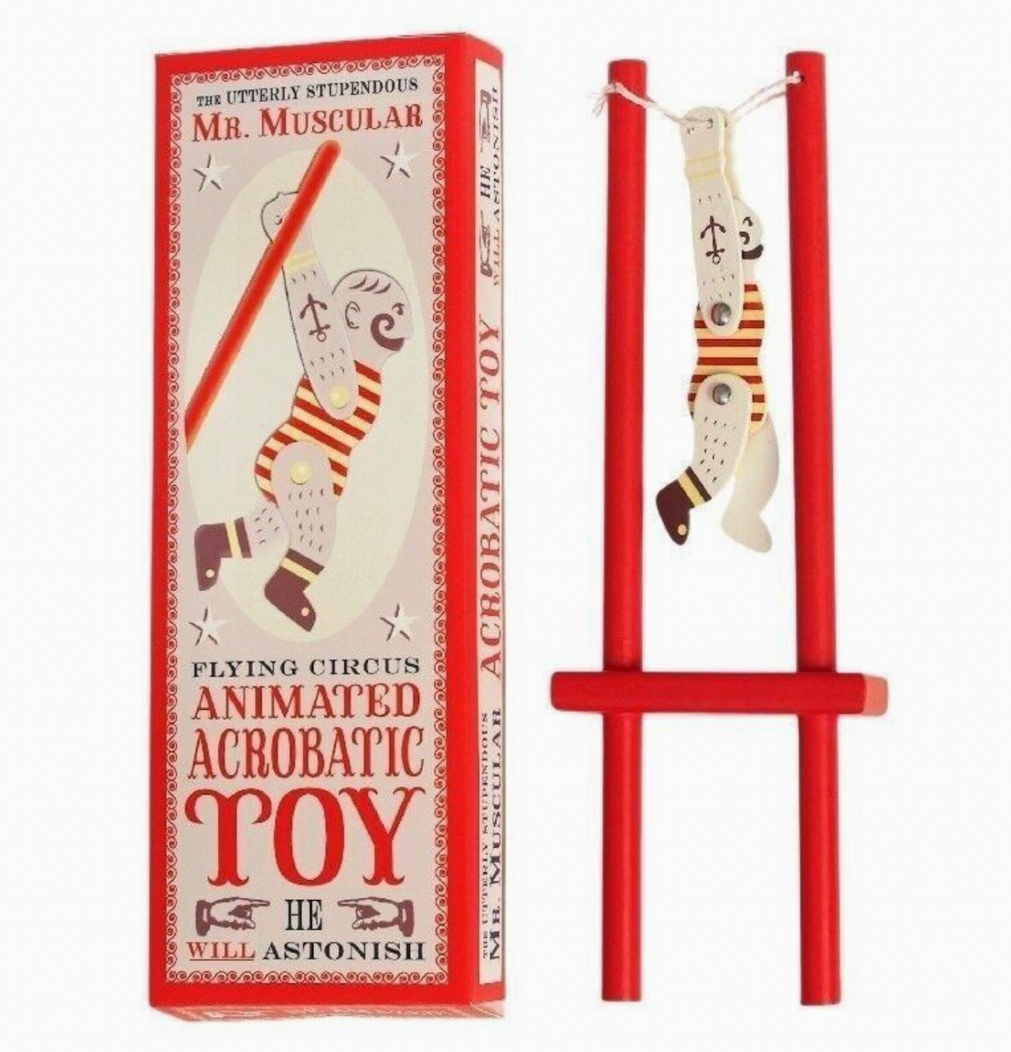 Left: tall red and cream vintage circus gift box reading "Flying Circus / Animated Acrobatic Toy / He Will Astonish"; right: assembled toy with figure hanging inverted