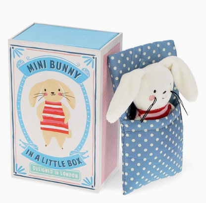 Box open next to closed box; matchbox drawer extended; bunny nestled in blue polka dot blanket pocket; full unboxing reveal