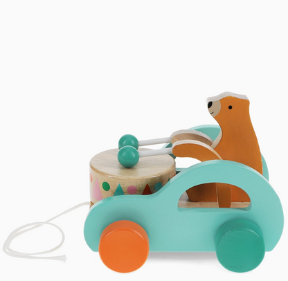 Three-quarter rear view; arch cut-out side detail; rear teal wheel; bear rear view; drum; cord from front; teal arch behind bear