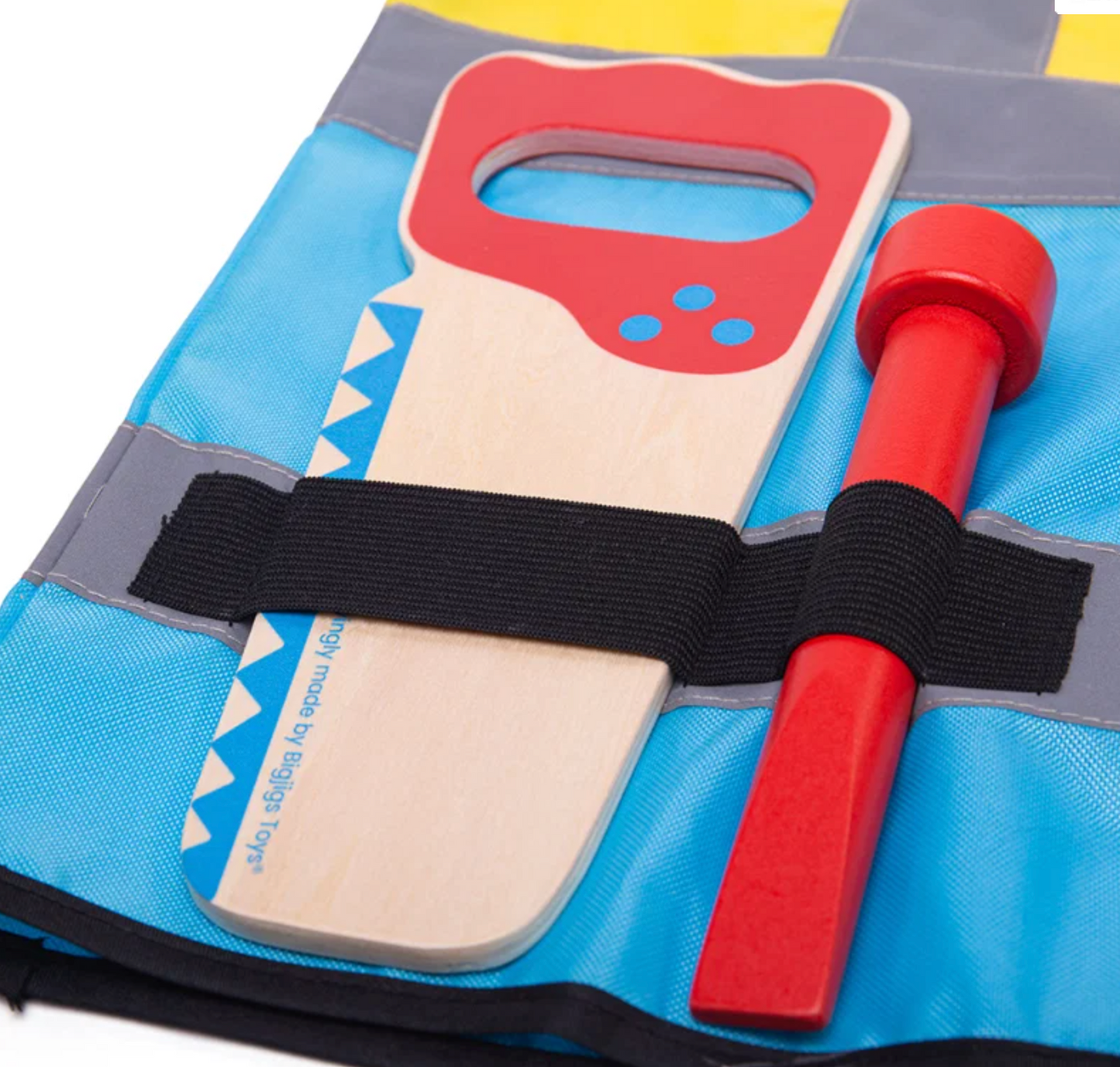 Close-up — left panel; saw (red handle, blue zigzag teeth, branding) and red chisel in elastic loops