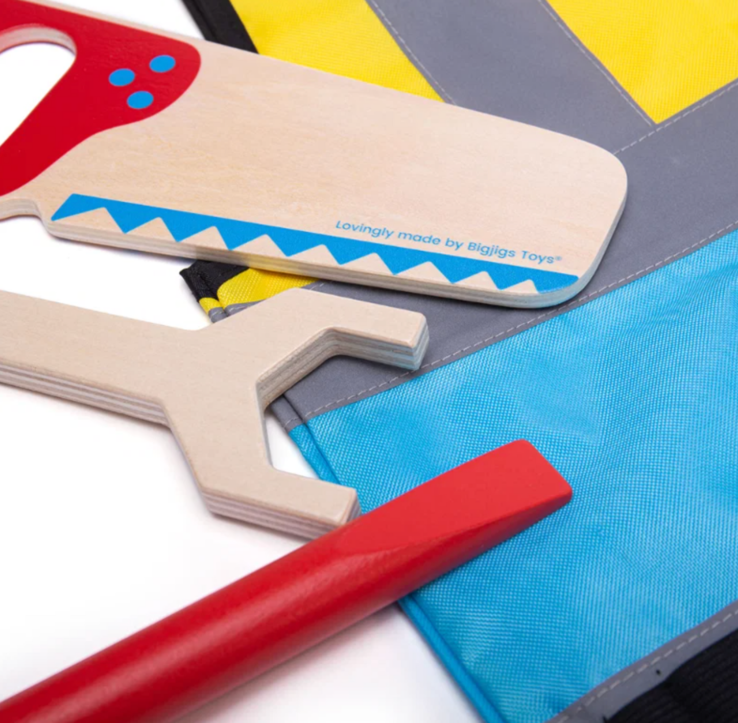 Close-up — saw blade detail, "Lovingly made by Bigjigs Toys" text, spanner and chisel 