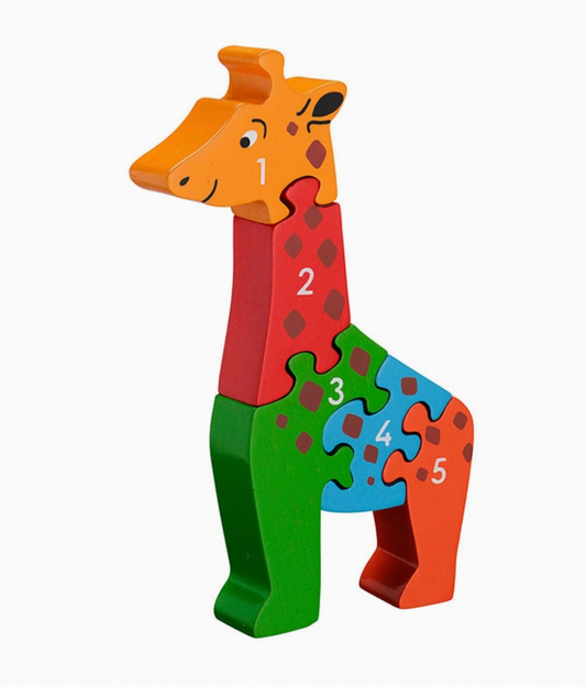 Standing giraffe; 5 pieces in orange, red, green, sky blue and rust; brown diamond spots across all pieces; characterful face with ossicone horns, black eye and nostril marks; white numbers 1–5; upright sculptural silhouette