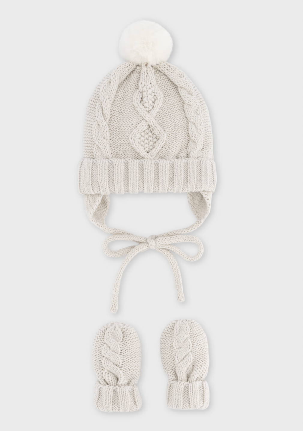 Grey background product shot — hat and mittens upright; the cleanest, most polished version of the set